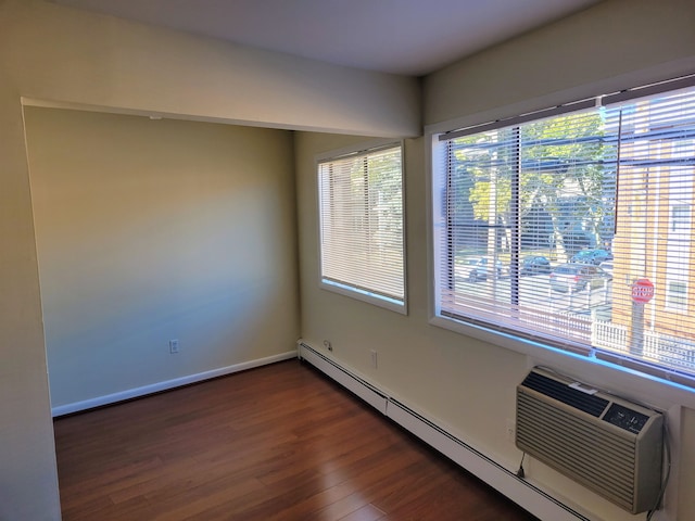 unfurnished room featuring dark hardwood / wood-style flooring and baseboard heating