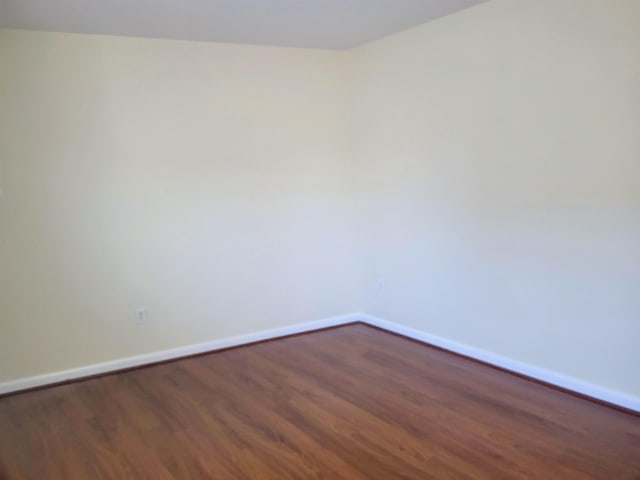 unfurnished room with dark hardwood / wood-style floors