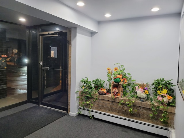 doorway to property with a baseboard heating unit