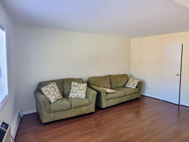 living room featuring a healthy amount of sunlight, a baseboard radiator, and dark hardwood / wood-style flooring