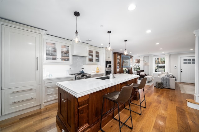 249 Grove St Unit 1, Jersey City, NJ 07302 - kitchen featuring recessed lighting, light wood-type flooring, stainless steel stove, light countertops, and a breakfast bar