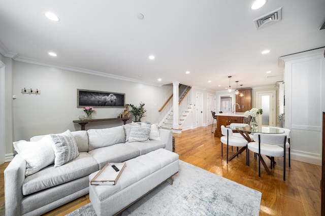 249 Grove St Unit 1, Jersey City, NJ 07302 - living area featuring crown molding, recessed lighting, light wood-style floors, and stairway