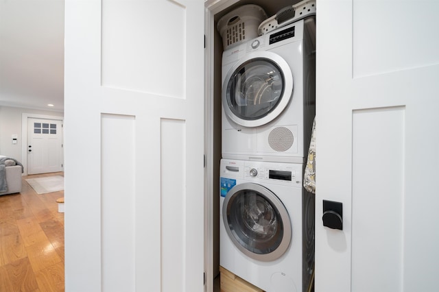 249 Grove St Unit 1, Jersey City, NJ 07302 - washroom featuring stacked washing machine and dryer, light wood-type flooring, and recessed lighting