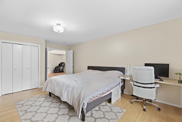 bedroom featuring a closet, baseboards, and light wood finished floors