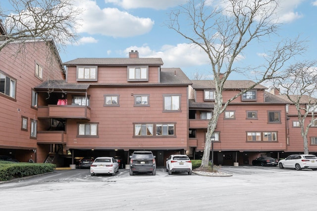 view of building exterior with uncovered parking