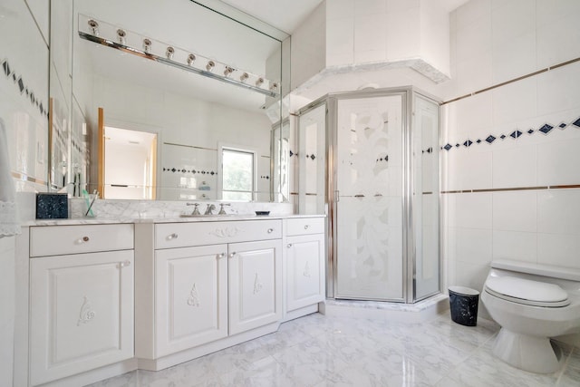 bathroom featuring walk in shower, vanity, tile walls, and toilet