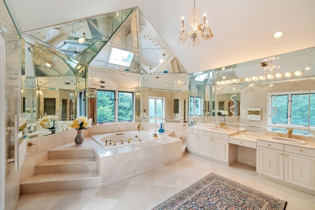 bathroom featuring tiled bath, vanity, a healthy amount of sunlight, and a skylight