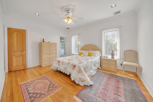 bedroom with ceiling fan, light wood-type flooring, and crown molding