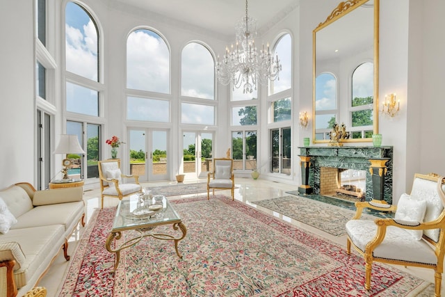 sunroom / solarium featuring a chandelier, a high end fireplace, and plenty of natural light