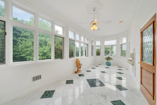 sunroom / solarium featuring ceiling fan