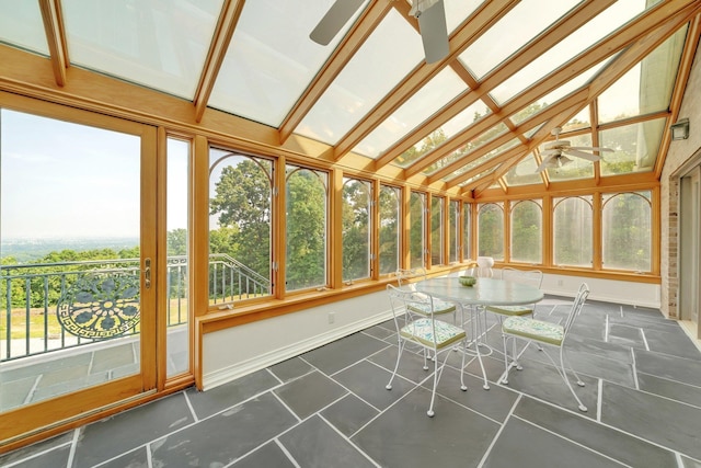 unfurnished sunroom featuring ceiling fan and vaulted ceiling