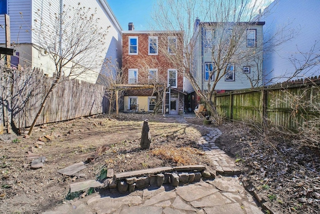 back of property with a fenced backyard