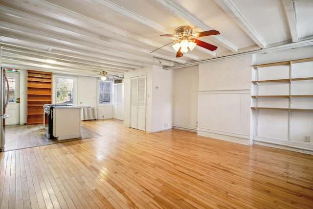 unfurnished living room featuring light wood-type flooring, beamed ceiling, radiator heating unit, and ceiling fan