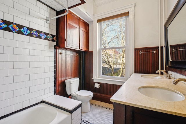 full bathroom with a healthy amount of sunlight, a bathtub, and a sink