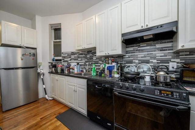 228 1st St Unit 3B, Jersey City, NJ 07302 - kitchen with a sink, white cabinetry, decorative backsplash, under cabinet range hood, and black appliances