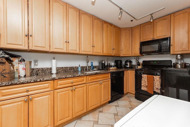 354 3rd St Unit 3, Jersey City, NJ 07302 - kitchen featuring black appliances, dark stone counters, and rail lighting