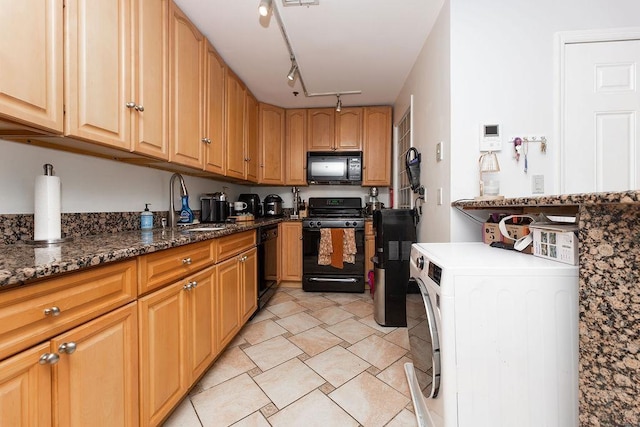 354 3rd St Unit 3, Jersey City, NJ 07302 - kitchen featuring black appliances, washer / clothes dryer, dark stone countertops, and rail lighting