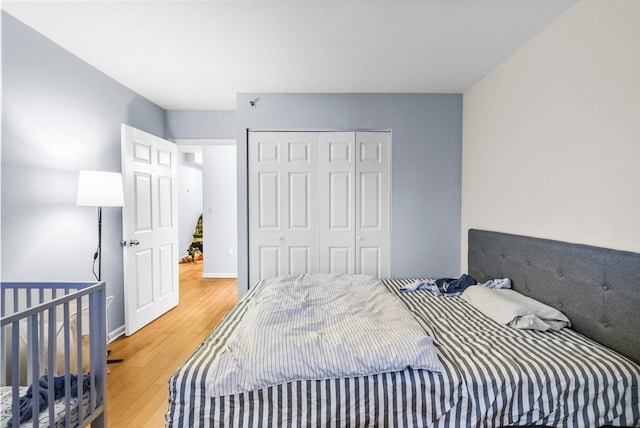 bedroom featuring wood-type flooring and a closet