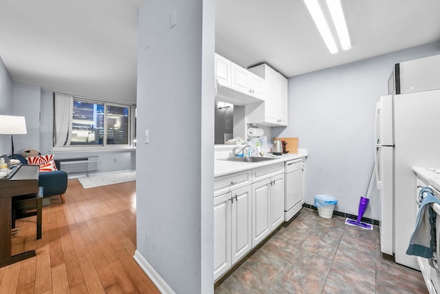 kitchen with white cabinetry, white appliances, and sink