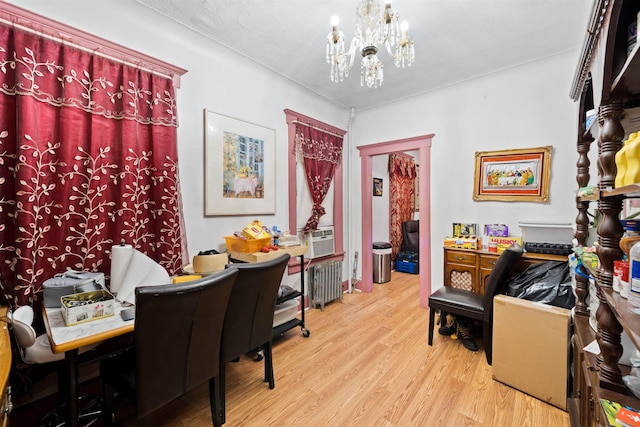 office featuring an inviting chandelier, radiator heating unit, and light hardwood / wood-style floors