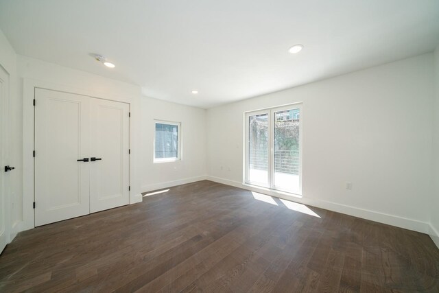 spare room featuring dark wood-type flooring