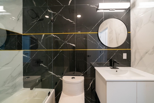 bathroom featuring vanity, toilet, and tile walls