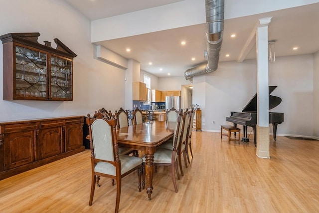 dining space with light wood-type flooring, baseboards, and recessed lighting