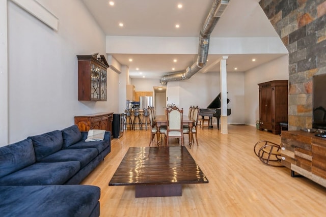 living area with recessed lighting and light wood-style floors