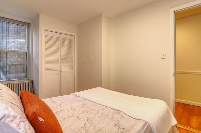 940 Bloomfield St # 1, Hoboken, NJ 07030 - bedroom with radiator heating unit, wood finished floors, and a closet