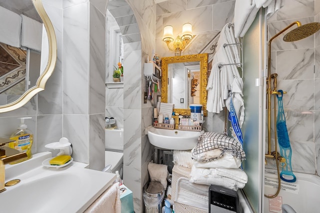 bathroom featuring vanity and tile walls