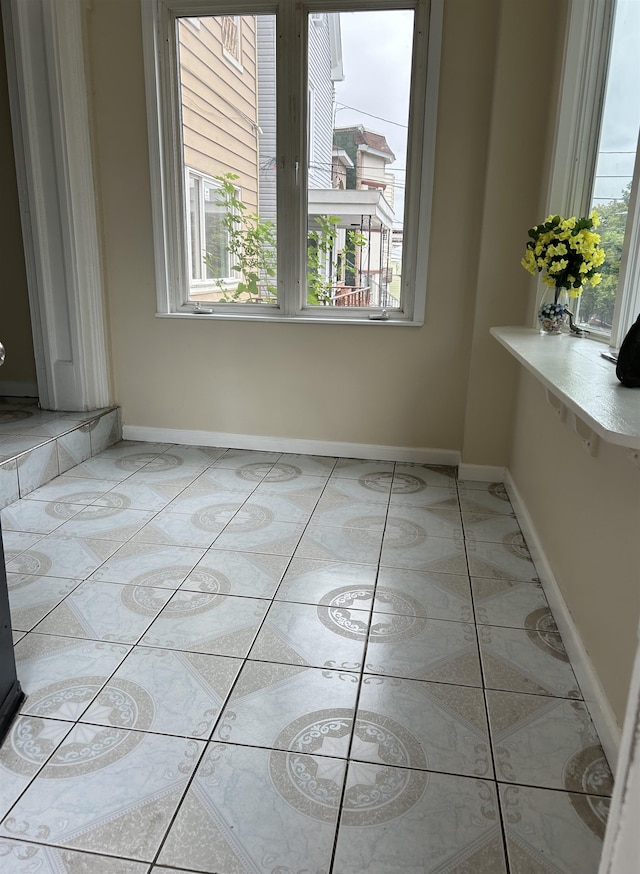 unfurnished dining area featuring light tile patterned flooring