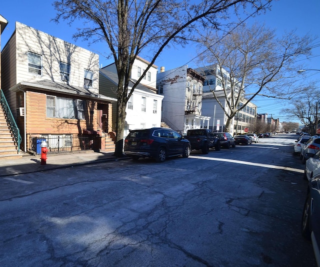 view of road with stairs, sidewalks, and a residential view