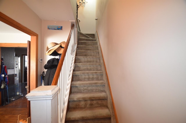 staircase with wood finished floors