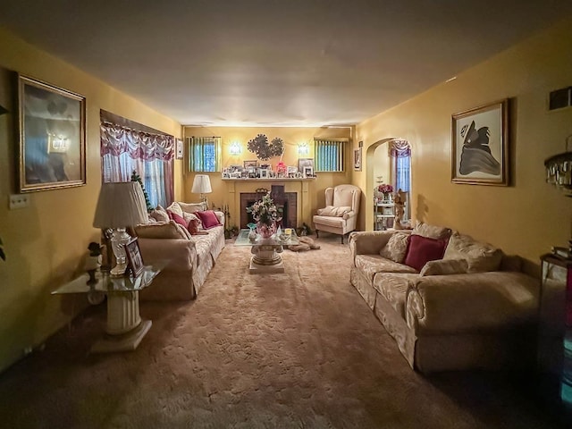 living room featuring carpet and a tiled fireplace