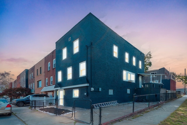 view of outdoor building at dusk