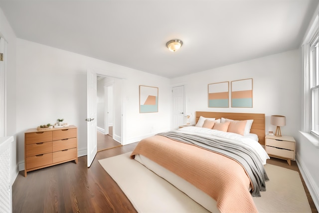 1007 88th St, North Bergen, NJ 07047 - bedroom with dark wood finished floors and baseboards
