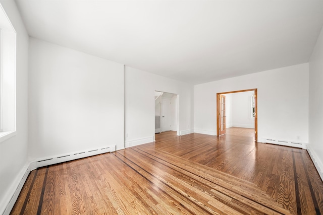 1007 88th St, North Bergen, NJ 07047 - unfurnished room with baseboard heating and wood finished floors