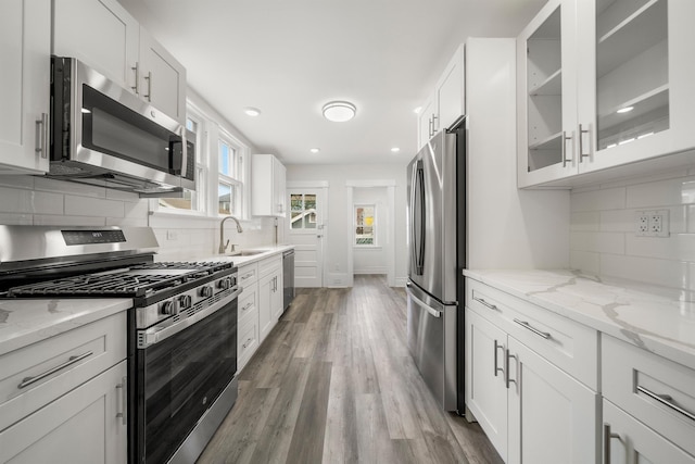 1007 88th St, North Bergen, NJ 07047 - kitchen with stainless steel appliances, white cabinets, backsplash, and recessed lighting