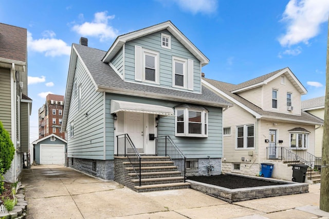 1007 88th St, North Bergen, NJ 07047 - view of front facade featuring an outbuilding, driveway, a detached garage, a chimney, and a shingled roof