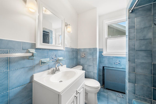 1007 88th St, North Bergen, NJ 07047 - full bath with tile walls, vanity, radiator, a shower, and wainscoting