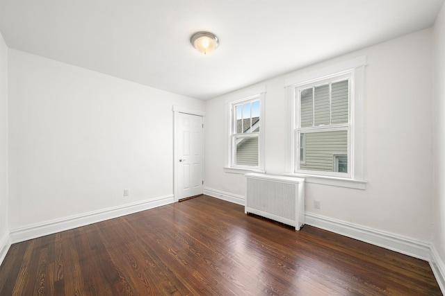 1007 88th St, North Bergen, NJ 07047 - empty room featuring radiator and wood finished floors