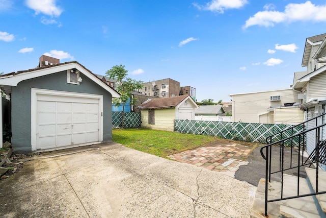 1007 88th St, North Bergen, NJ 07047 - detached garage with driveway and a residential view