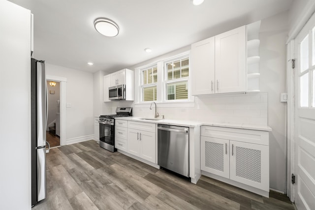 1007 88th St, North Bergen, NJ 07047 - kitchen featuring stainless steel appliances, open shelves, decorative backsplash, white cabinetry, and recessed lighting