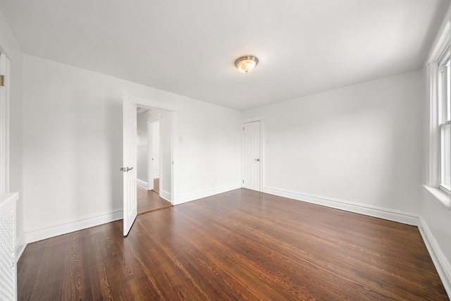 1007 88th St, North Bergen, NJ 07047 - empty room featuring dark wood-style floors and baseboards