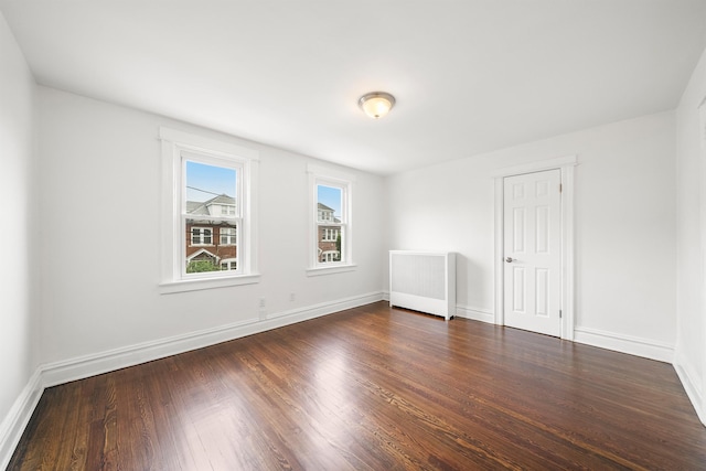 1007 88th St, North Bergen, NJ 07047 - spare room featuring dark wood-style flooring and radiator