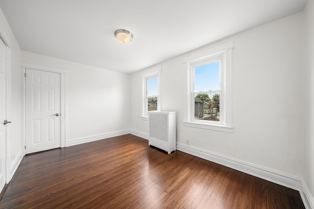 1007 88th St, North Bergen, NJ 07047 - spare room featuring radiator and dark wood-type flooring