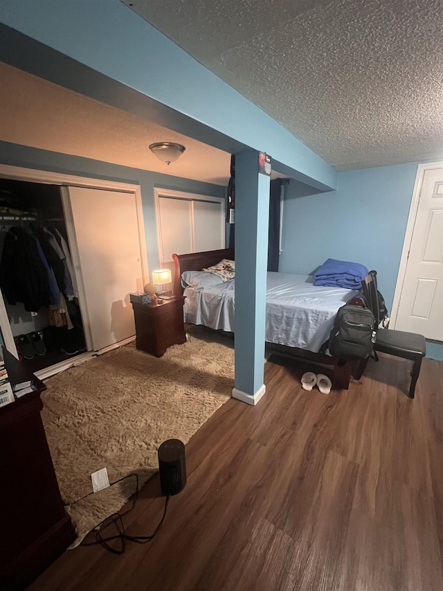 bedroom with wood-type flooring and a textured ceiling