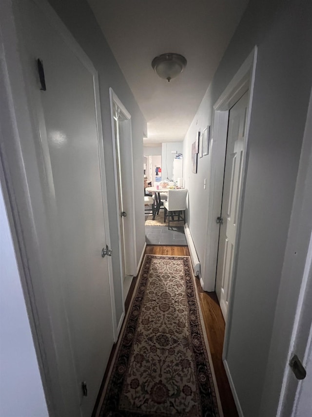 hallway with dark wood-type flooring