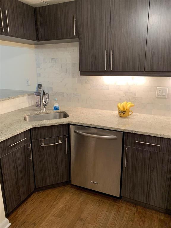 341 Monmouth St Unit 308D, Jersey City, NJ 07302 - kitchen featuring stainless steel dishwasher, dark wood finished floors, and dark brown cabinetry
