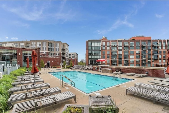 pool with a patio and fence